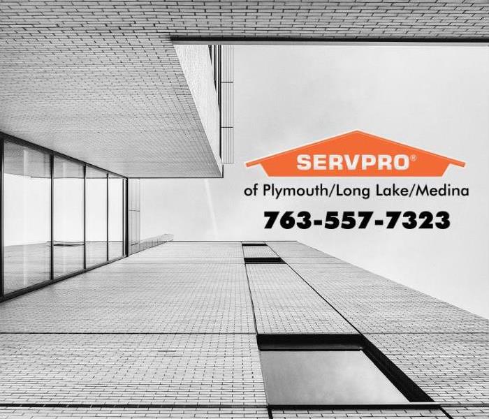 Grey office building with an orange SERVPRO logo.