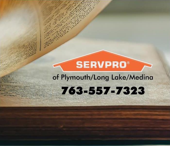 Turning page of a book with an orange SERVPRO logo.